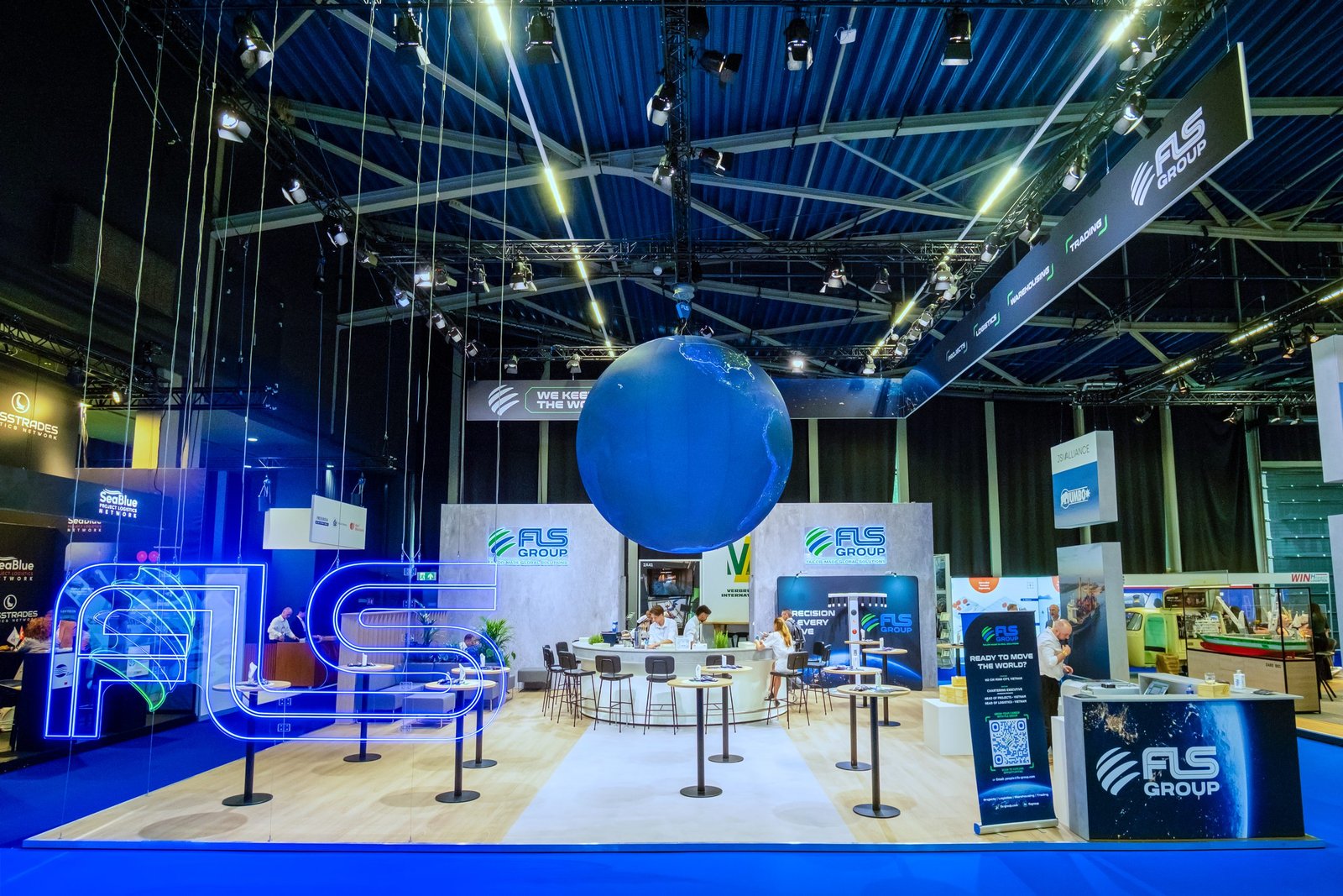 Front view of the FLS Group exhibition booth and suspended globe