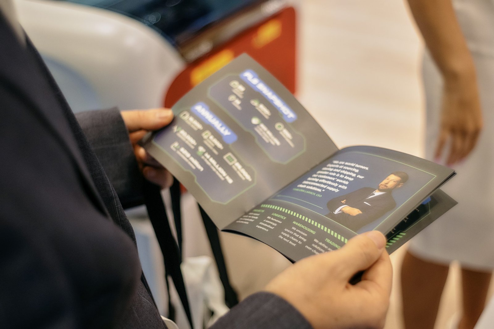 An attendee reading an FLS Group company brochure