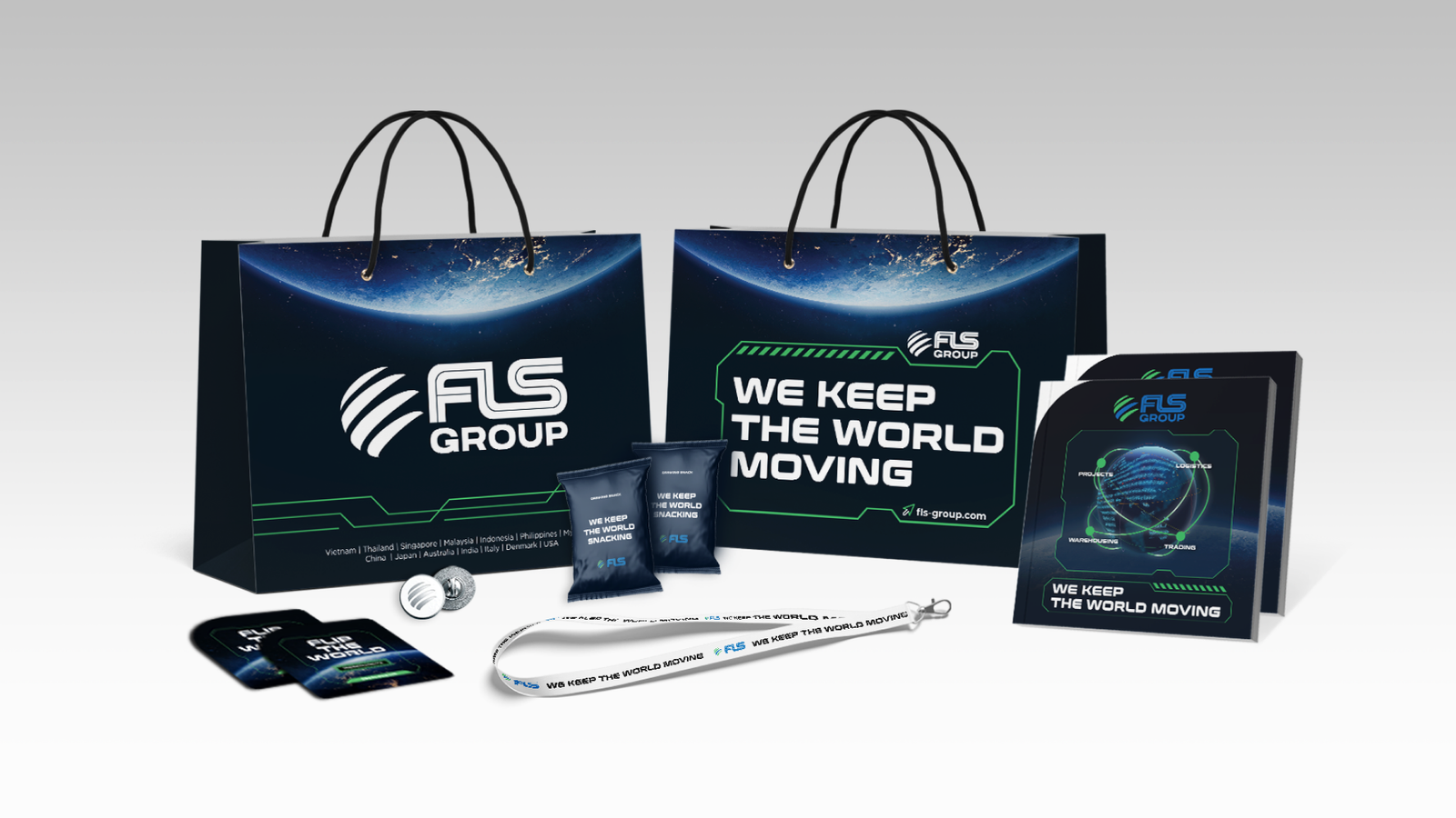 FLS Group branded merchandise kit including bags, notebooks, snacks, pins, lanyards, and cards